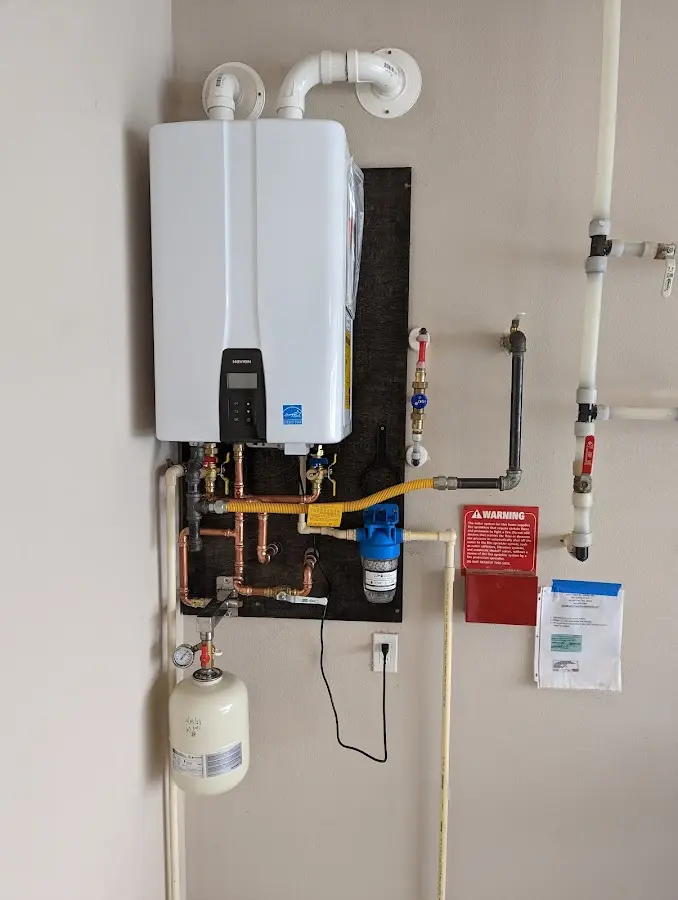 Professional plumber installing copper piping in a Long Beach home